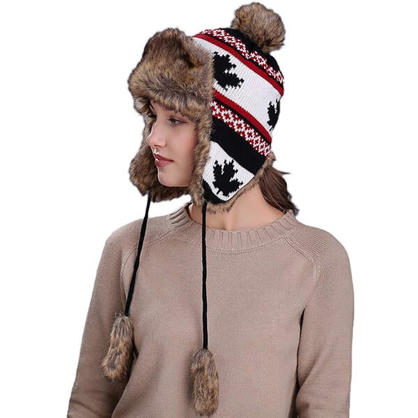 Knitted trapper hat with hanging pom-poms
